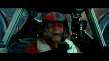a man wearing a helmet that says ' a ' on it is sitting in a car