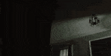 a person is standing in a room with smoke coming out of the windows .