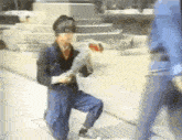 a man is kneeling down on the sidewalk holding a bouquet of flowers and a sword .