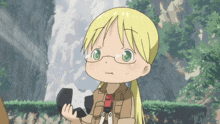 a girl with blonde hair and green eyes is holding a rock