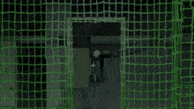 a man is swinging a bat at a baseball in a prison cell .