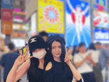 a woman wearing a mask and a hat with the letter jc on it