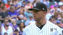 a baseball player with the letter r on his cap