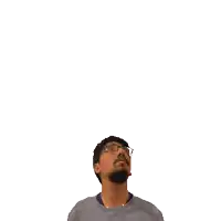 a man with glasses looks up at a green cross on his head