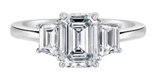 a white gold ring with three emerald cut diamonds