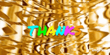 the word thanks is displayed in colorful letters on a gold background
