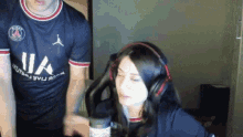 a man and a woman are sitting in front of a microphone .