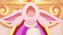 a pink and purple cartoon character is standing in front of a wall holding a key .
