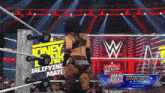 a woman in a wrestling ring with a banner that says main event on it