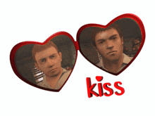 two red heart shaped mirrors with the word kiss on it