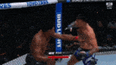 two men are fighting in a boxing ring with a bud light banner behind them