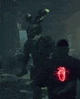 a man in a black jacket with a heart on the back