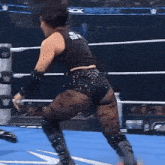 two women are wrestling in a ring and one of them is wearing a black shirt that says nightmare