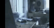 a blurry picture of a desk with a bun.com logo on the bottom right