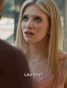 a woman in a pink dress is talking to a man and says like this