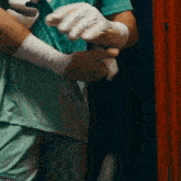 a person is wrapping their hands in boxing gloves with a puma logo on their shorts