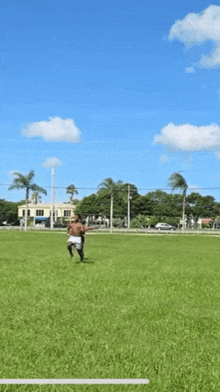 two men are playing in a grassy field and one is laying on his back
