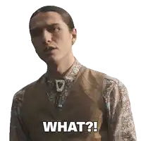 a man wearing a vest and a floral shirt is asking what
