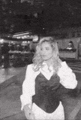 a black and white photo of a woman in a corset and white shirt