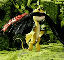 a yellow and black dragon is standing in the grass with its wings outstretched .