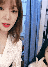 a woman in a white lace top looks at another woman