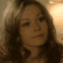 a close up of a woman 's face with her eyes closed .