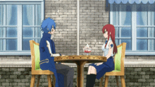 a man and a woman are sitting at a table in front of a brick building