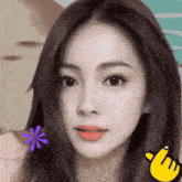 a close up of a woman 's face with a yellow finger pointing to the right