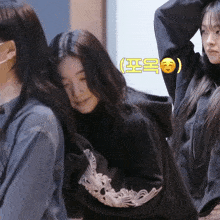 a girl wearing a black sweatshirt with a skull on the sleeve