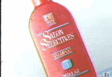 a red bottle of salon selectives shampoo is sitting on a white surface