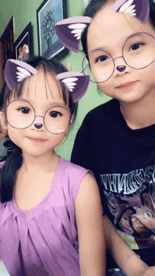 two little girls wearing cat ears glasses and a shirt that says vthma