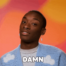 a man is wearing a blue sweater and says damn