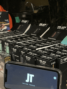 a display of xblack boxes and a phone with the jt logo on the screen