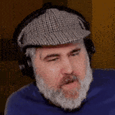 a man with a beard and hat is wearing headphones