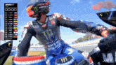 a motorcycle racer is wearing a helmet that says monster on it
