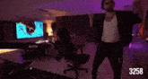 a man is standing in a room with the number 3258 on the bottom right