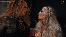 two women are standing next to each other and the word toodles is visible