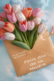 a bouquet of flowers in a brown envelope with feliz dia de la madre written on it