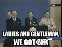 a group of men are standing behind a podium giving a speech .
