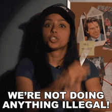 a woman says we 're not doing anything illegal in front of a bulletin board