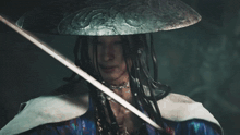 a man wearing a hat and holding a sword