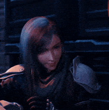 a woman in armor holds her finger to her lips