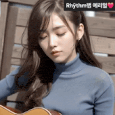 a woman in a blue turtleneck is playing a guitar with rhythm written on the bottom