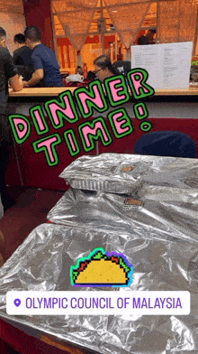a sign that says dinner time at the olympic council in malaysia