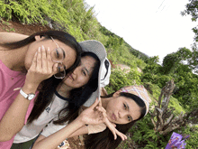 three girls are posing for a picture with one wearing a shirt that says ' a ' on it