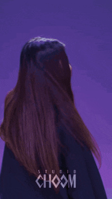 a woman is wearing a black sweatshirt that says choom studio