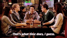 a group of people sitting around a table with the words " that 's what time does i guess "
