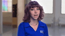 a woman wearing a blue shirt that says best buy on it