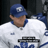 a hockey player wearing a milk jersey and a blue hat