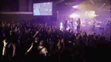 a crowd of people watching a band on stage